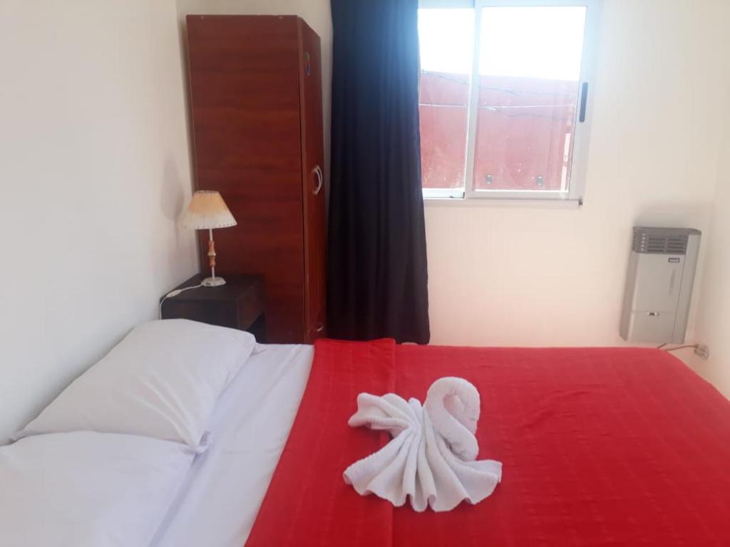 a white towel is sitting on a bed at Matices in Gualeguaychú