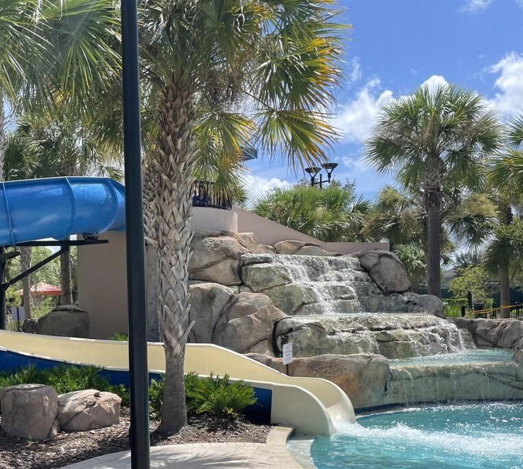 a water slide in a pool with a waterfall at 4159 -Private Pool&Spa at Resort-slides in Davenport