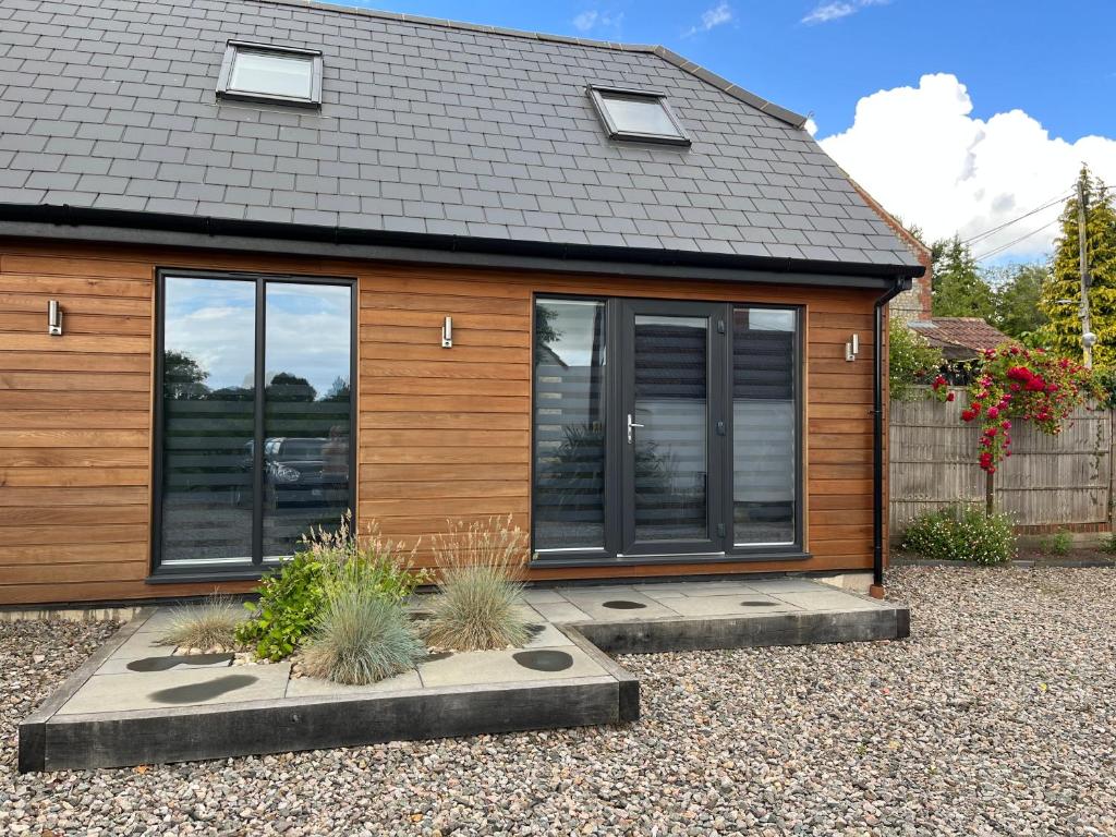 a home with a wooden house with windows at Luxury stay Kings Annexe 5 minutes from Longleat in Warminster