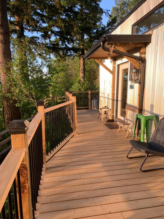 a wooden deck with benches on a house at Tiny House Big View in Chilliwack