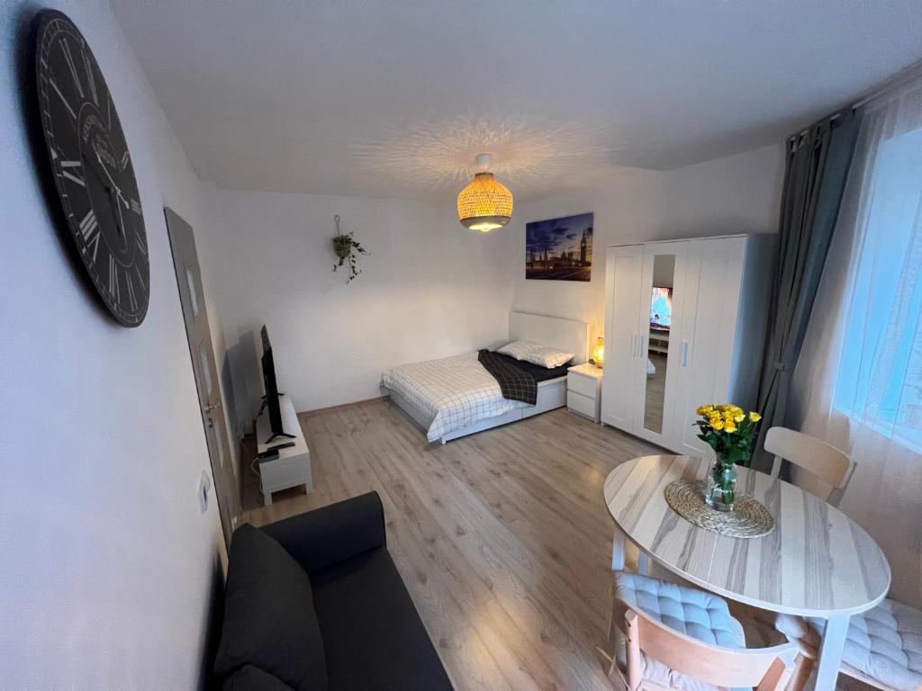 una pequeña sala de estar con mesa y sofá en London Apartments, en Katowice