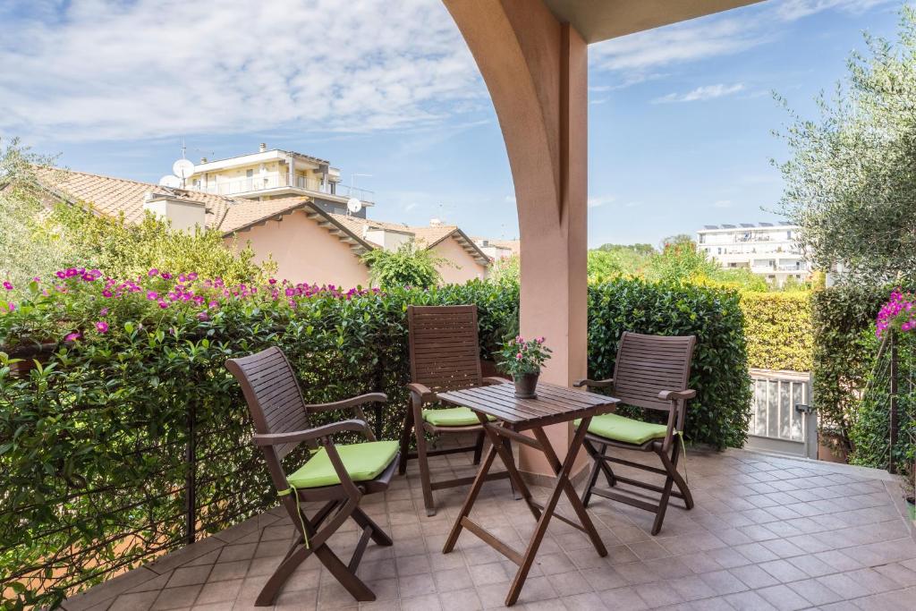 a patio with a table and chairs on a patio at B&B L'Ulivo Fiumicino in Fiumicino