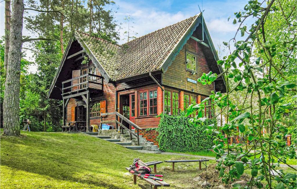 a large wooden house in the middle of a yard at 3 Bedroom Stunning Home In Grunwald in Mielno