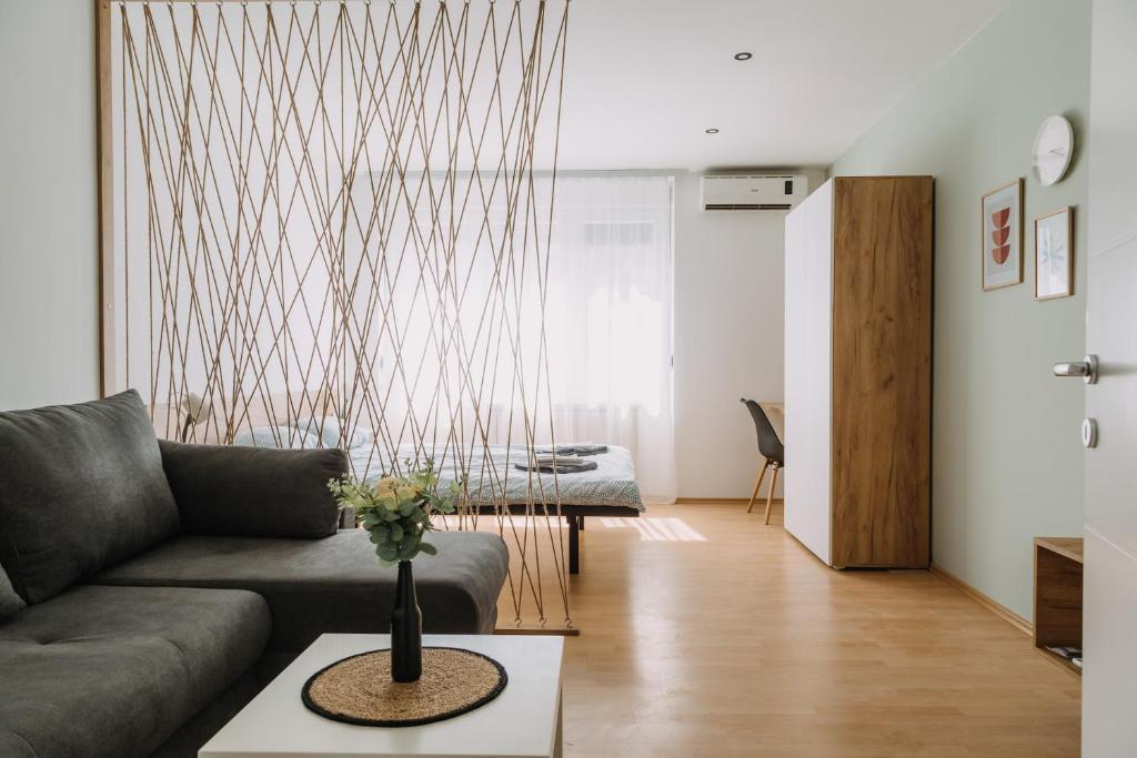 a living room with a couch and a table at Constantin Inn in Niš