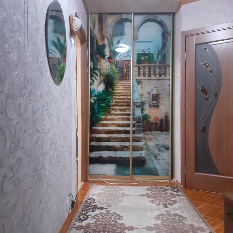 a hallway with a door with a painting of a stairway at Lachis@ Chisinau in Chişinău