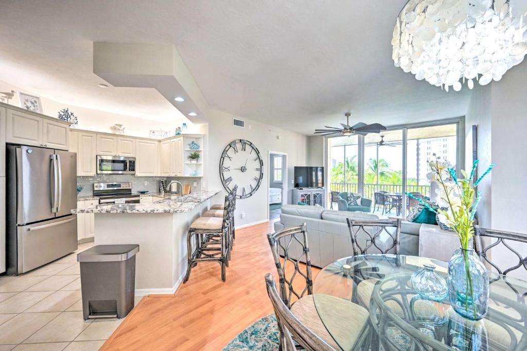 a kitchen and living room with a clock on the wall at Naples Escape in Regatta with Resort Amenities! in Naples