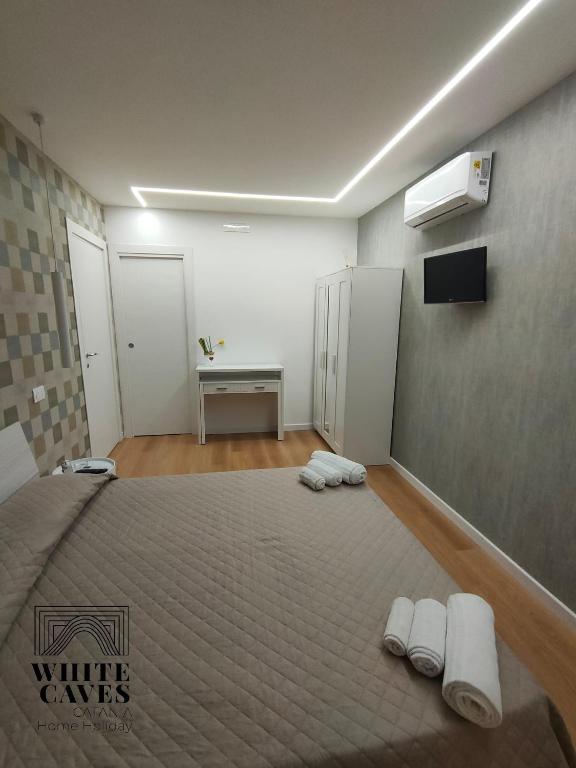 Posteľ alebo postele v izbe v ubytovaní white caves catania rooms