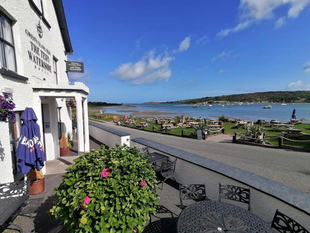 a balcony of a building with a view of the water at The Teifi Waterside Hotel in Cardigan