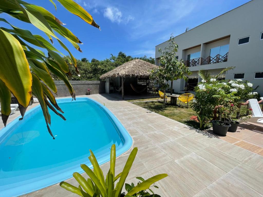 a swimming pool in the backyard of a house at Chalé Murici Lençóis in Santo Amaro