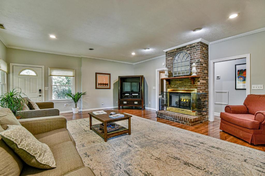 a living room with a couch and a fireplace at South Asheville home with hot tub just 11 miles to downtown in Asheville