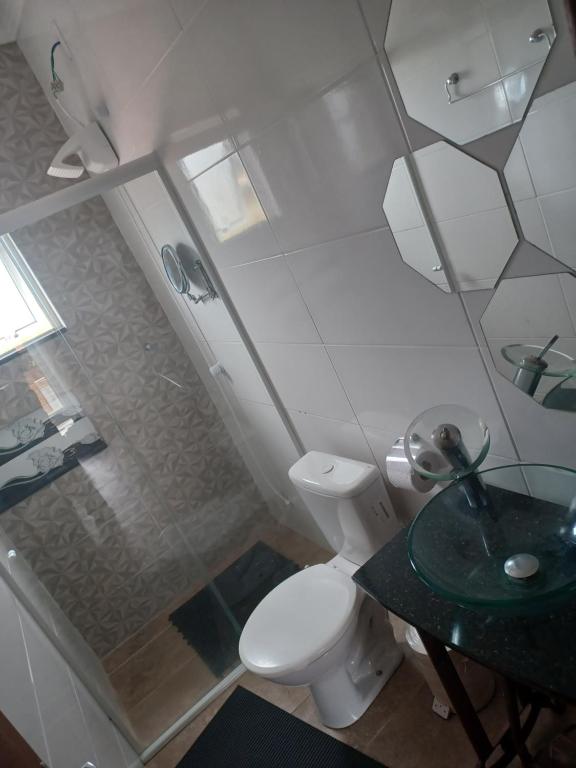 a bathroom with a shower and a toilet and a sink at Sobrado novo in Florianópolis