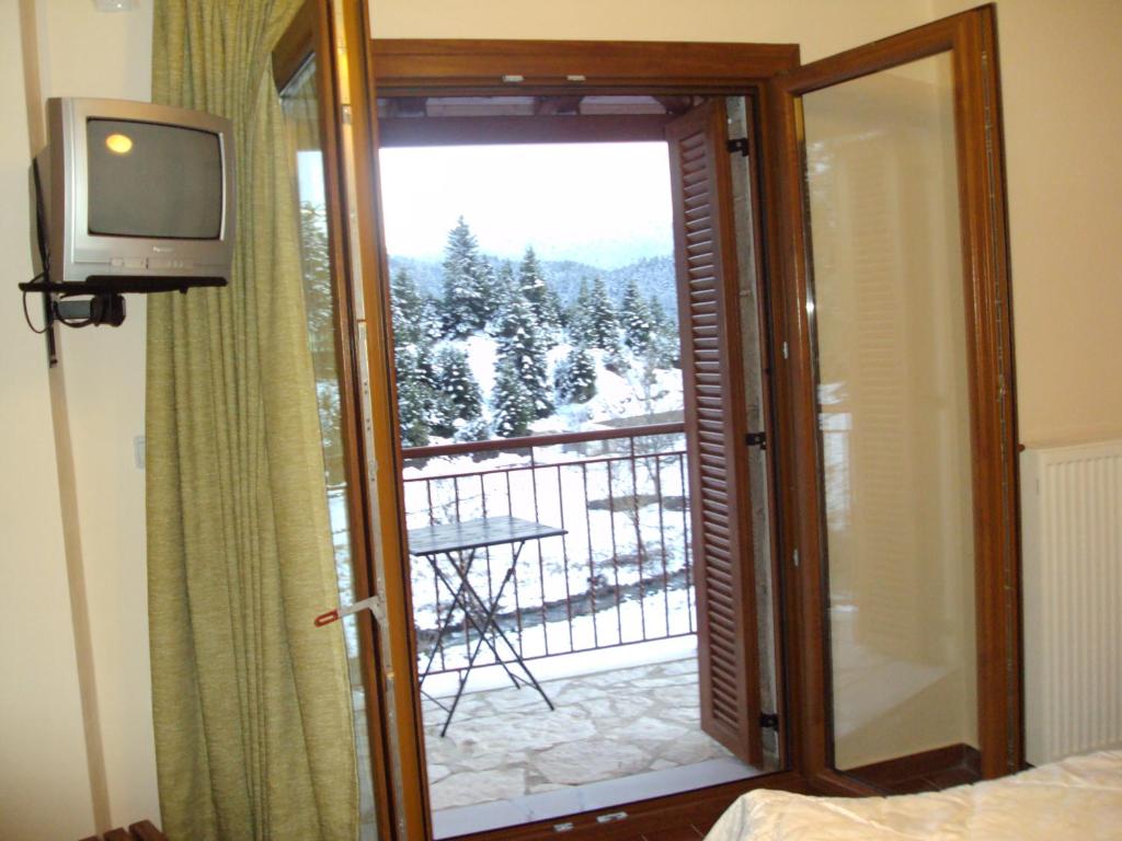 Telewizja i/lub zestaw kina domowego w obiekcie Guest House Pantos Kairou