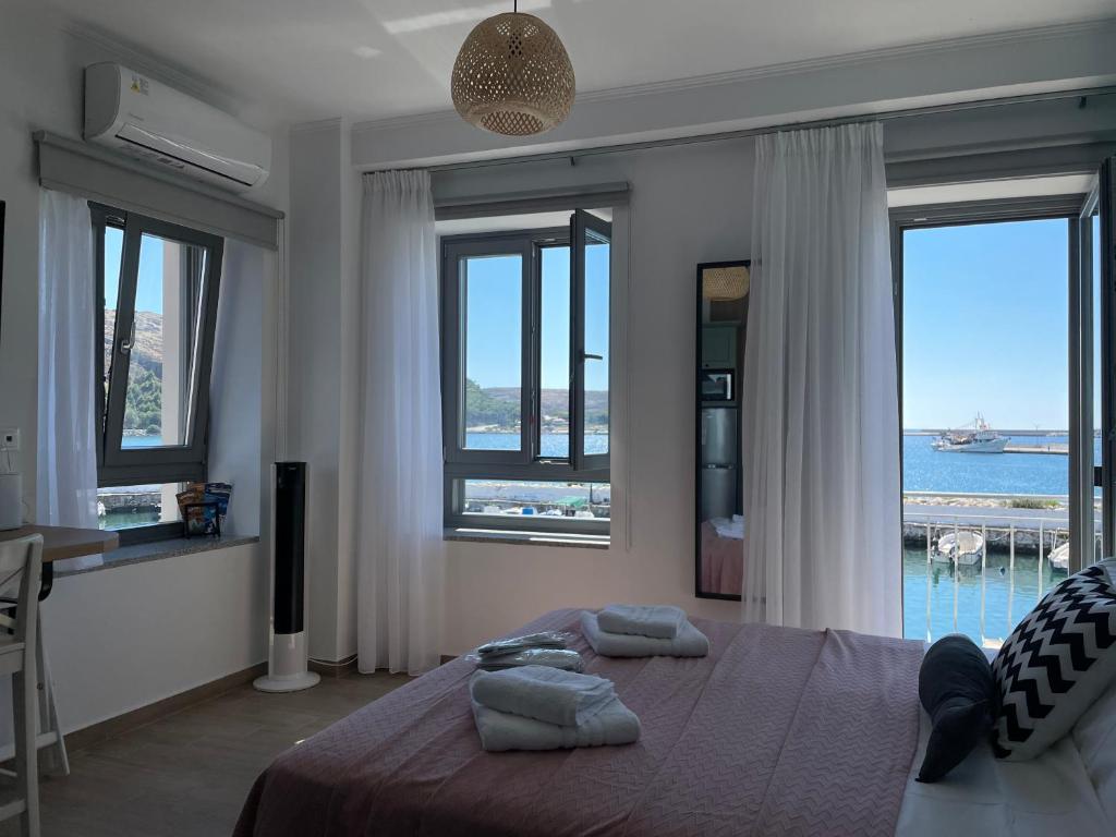 Schlafzimmer mit einem Bett und Meerblick in der Unterkunft «ΑΓΝΑΝΤΙΟ l» Δωμάτιο με μοναδική θέα! in Mirina
