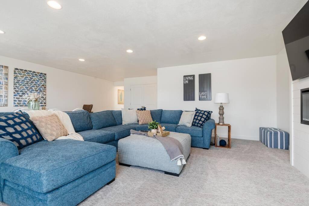 a living room with a blue couch and a chair at Bear Lake Beautiful Brand New End Unit in Garden City