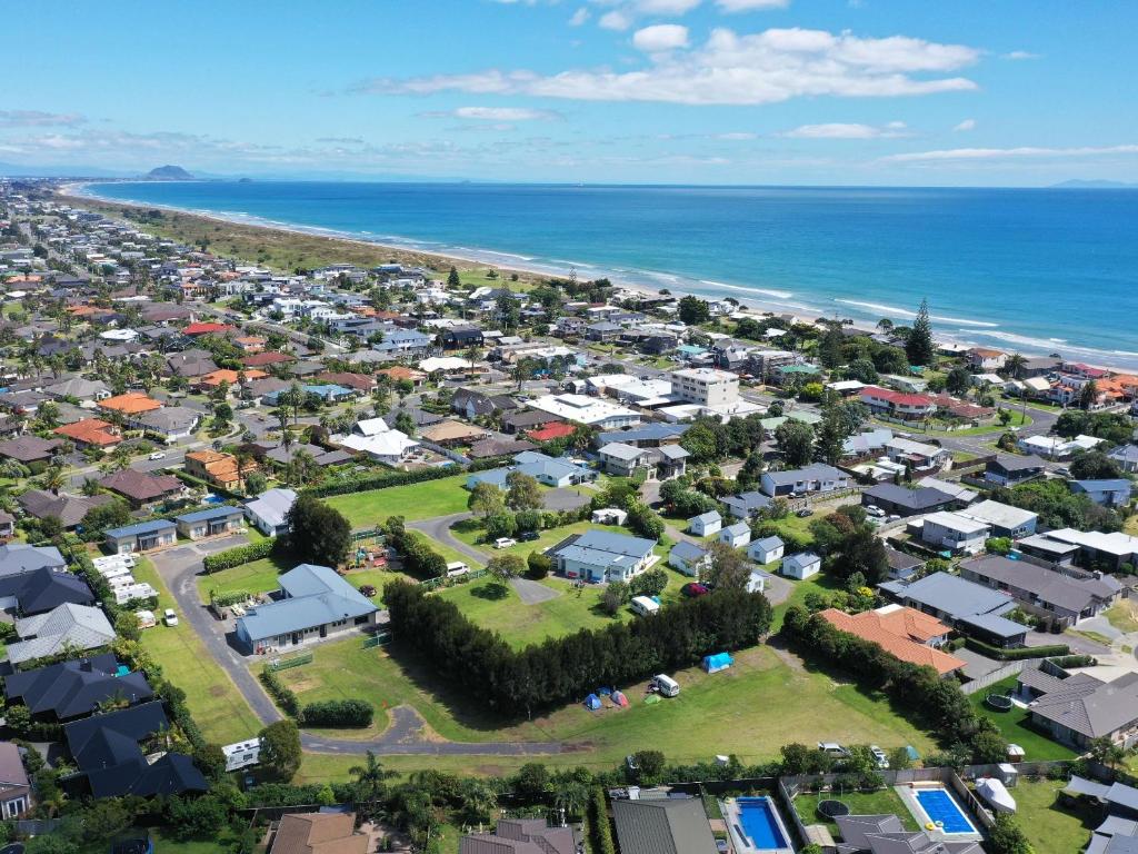 an aerial view of a suburb next to the ocean at Pacific Park Christian Holiday Camp in Papamoa