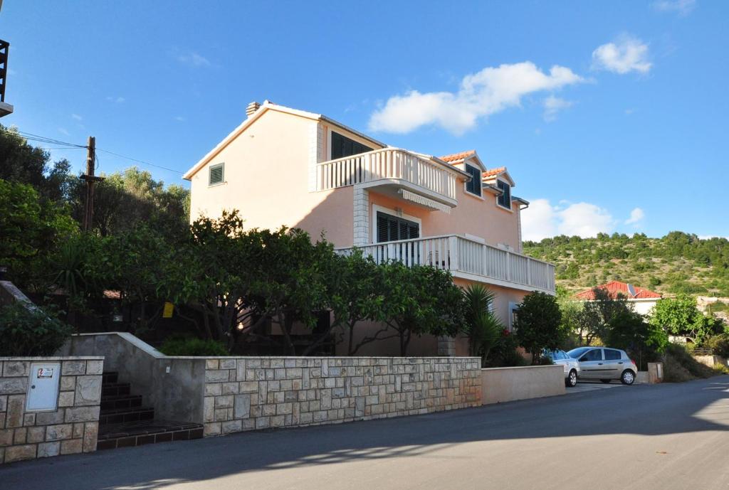 a house with a car parked in front of it at Apartments by the sea Vela Luka, Korcula - 9244 in Vela Luka