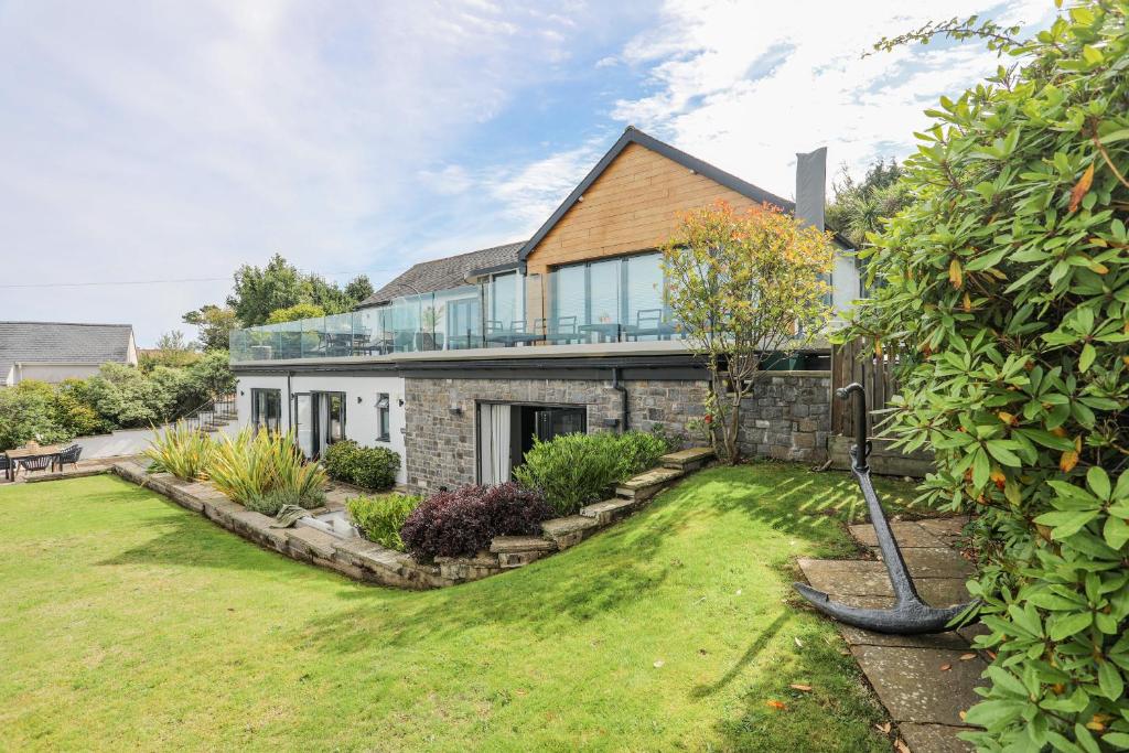a house with a large yard in front of it at Trem Y Borth Apartment in Abersoch