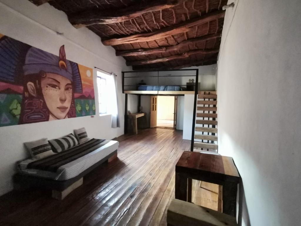 a living room with a couch and a painting on the wall at Vientos - La Yareta in San Pedro de Atacama