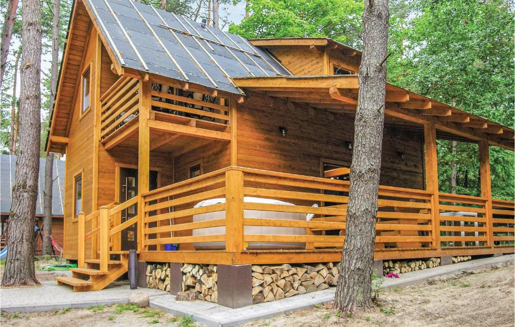 a large wooden house with a solar roof at 2 Bedroom Pet Friendly Home In Ostroda in Ostróda