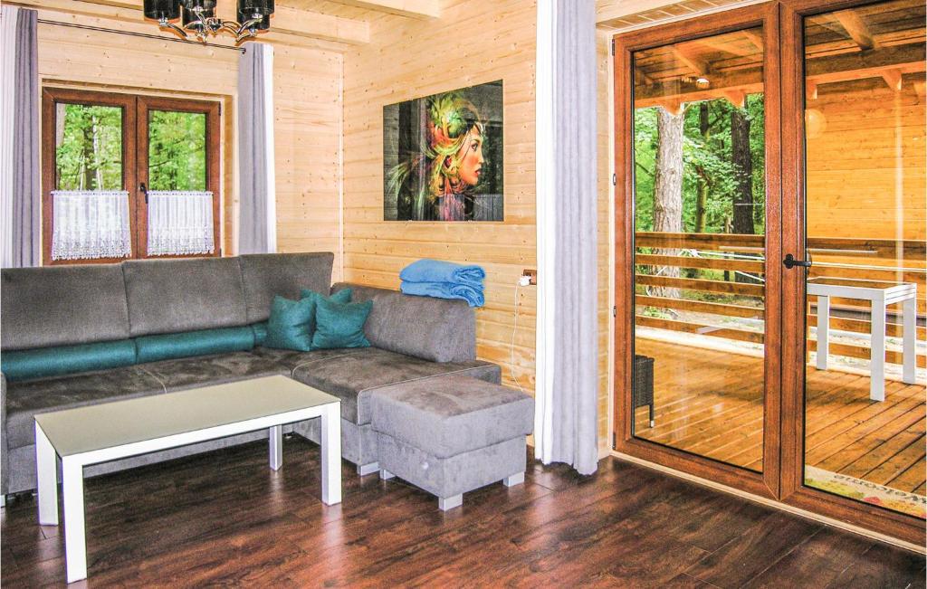 a living room with a couch and a table at 2 Bedroom Pet Friendly Home In Ostroda in Ostróda