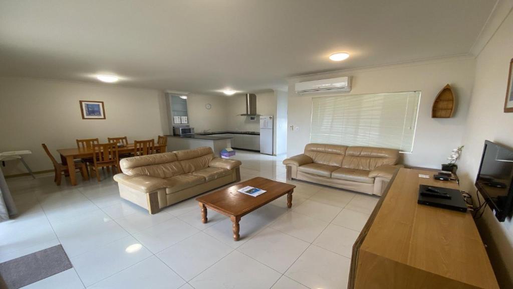 a living room with two couches and a table at Unit 63 Seafront Estate in Jurien Bay
