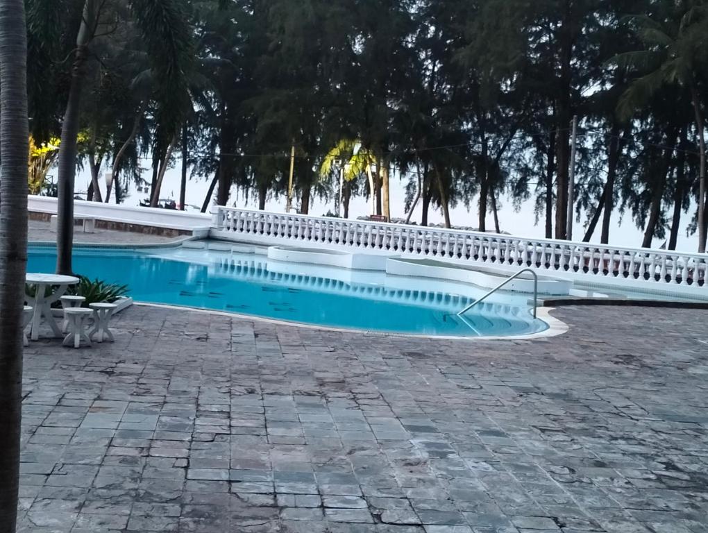 une piscine entourée d'une clôture blanche. dans l'établissement Pantai Puteri Kondominium, à Kampong Bukit Darat