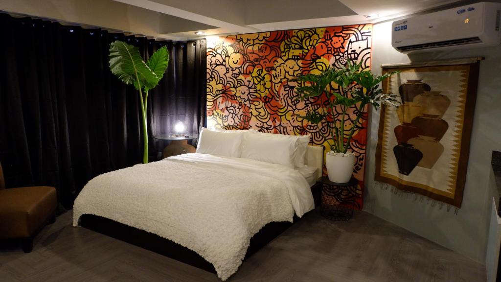 a bedroom with a bed and a colorful wall at Havitat Boutique Hotel in Manila