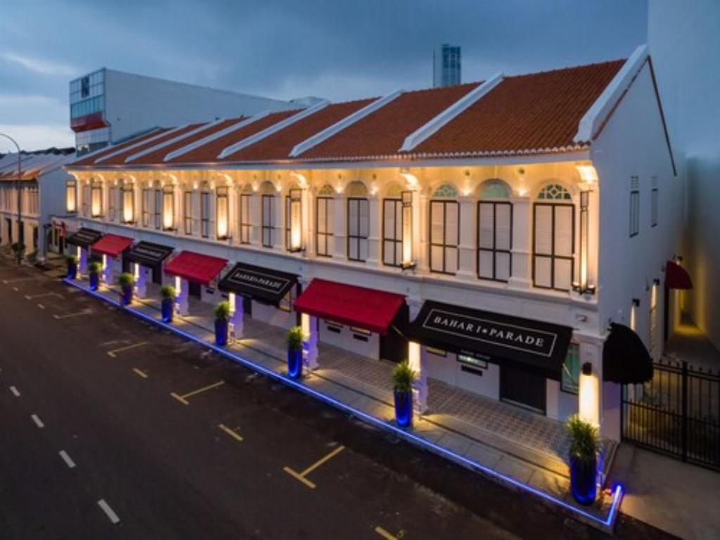 a building with red awnings on a street at Bahari Parade Hotel Managed by The Ascott Limited in George Town