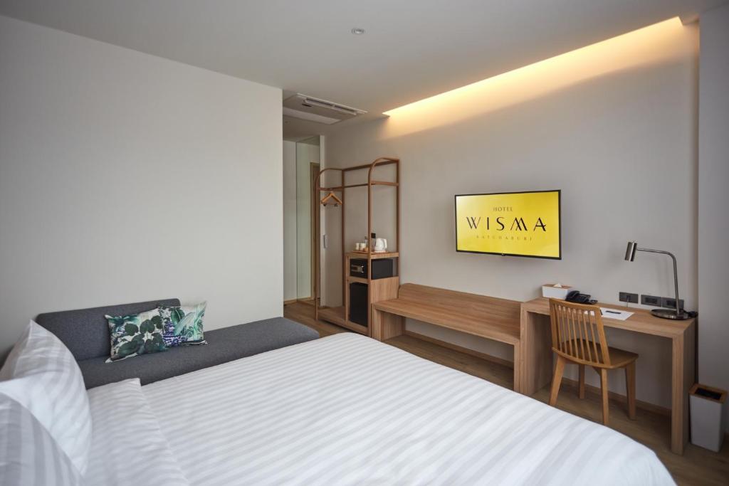 Postel nebo postele na pokoji v ubytování Centara Life Wisma Hotel Ratchaburi