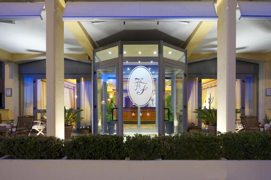 a large clock in the middle of a building at Hotel Florida Lerici in Lerici