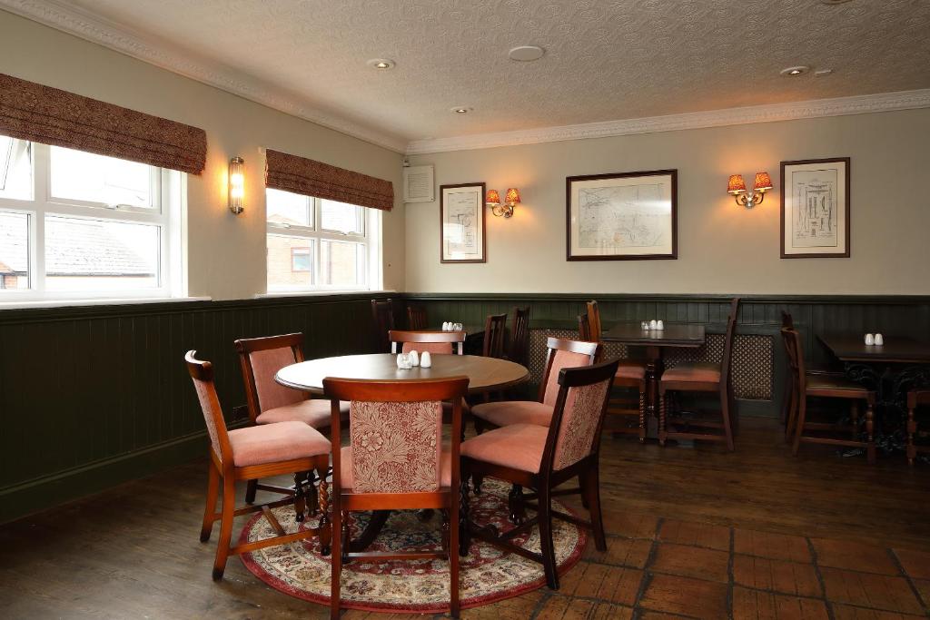 a restaurant with tables and chairs in a room at The Avenue in Durham