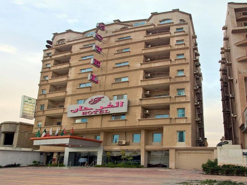 a tall building with a sign on the side of it at Al Farhan Apartment (Al Jubail-Al Balad ) in Al Jubail
