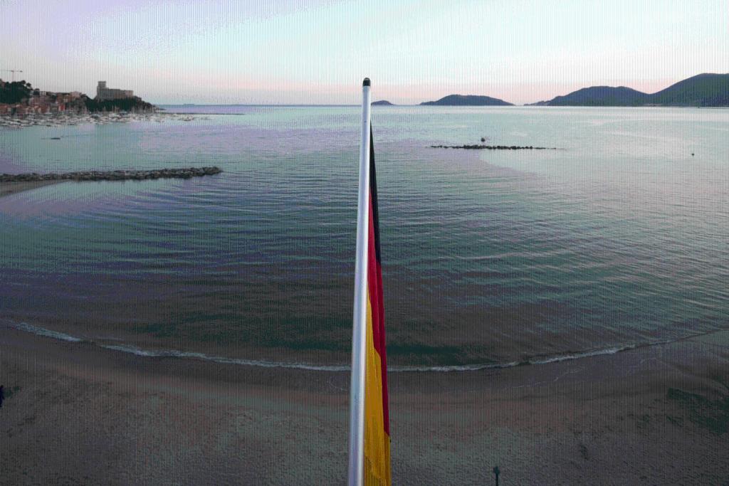 a flag on the beach next to the water at Hotel Florida Lerici in Lerici