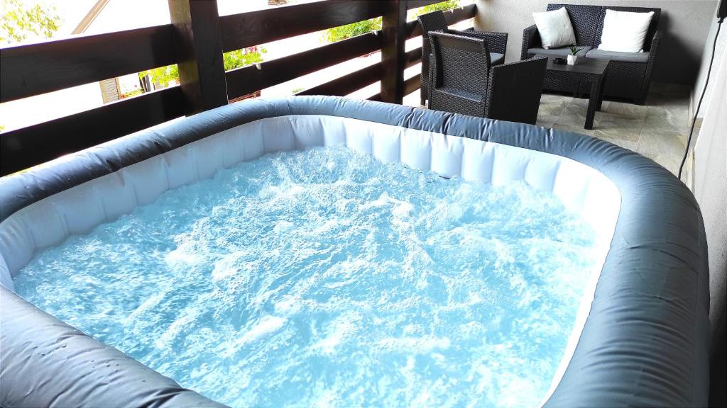 a large pool of water on a balcony at Deluxe Apartment with Jacuzzi PATAR in Rakovica