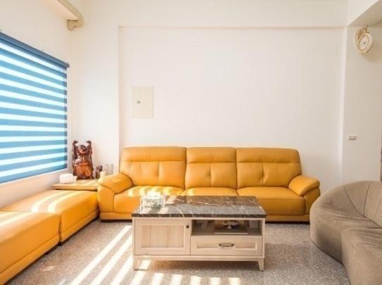 a living room with a couch and a coffee table at Chang Hiong Homestay in Yilan City