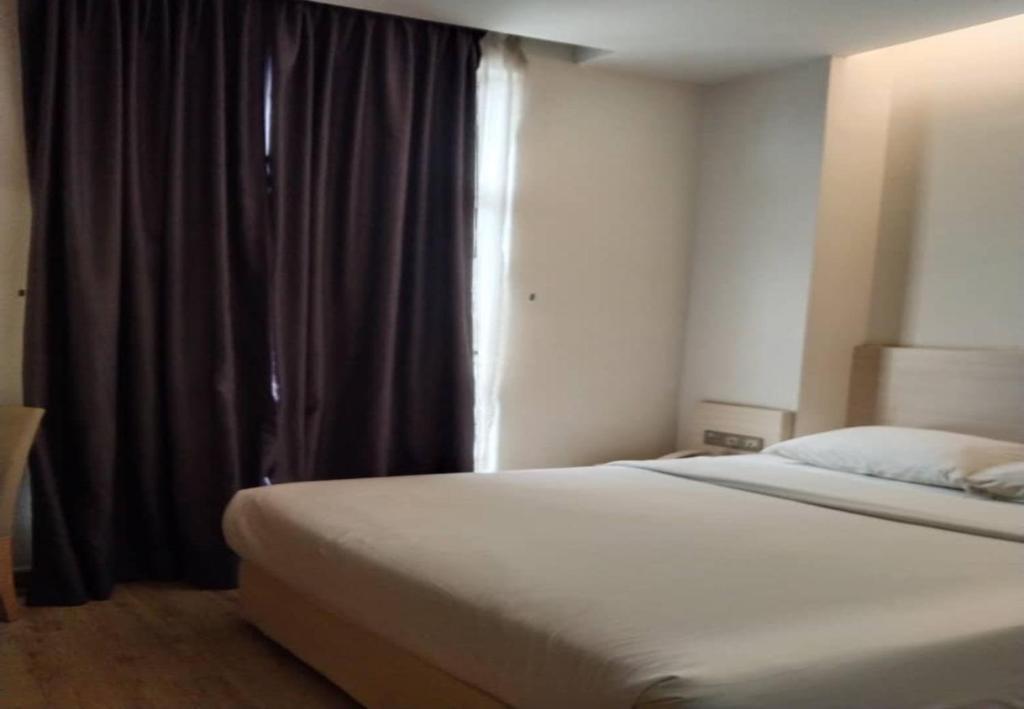 Postel nebo postele na pokoji v ubytování Minimalist Hotel