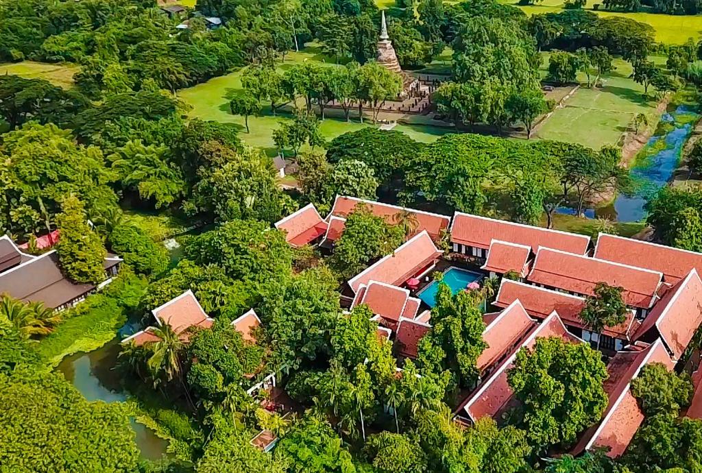 an aerial view of a resort with a pool and trees at Legendha Sukhothai Hotel - SHA certified in Sukhothai