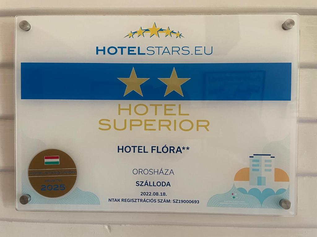 a sign for a hotel superulator on a wall at Hotel Flóra** in Orosháza