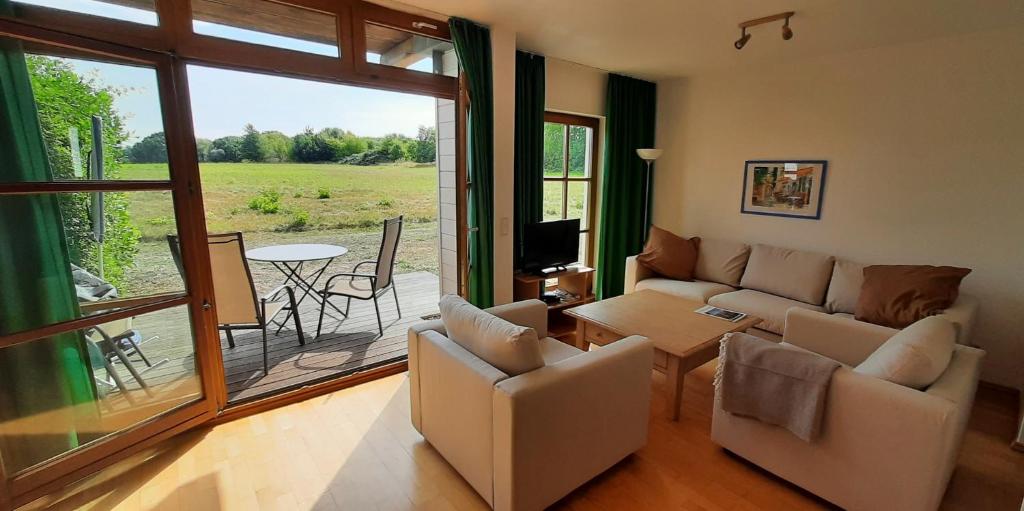 a living room with a couch and a table at Ferienwohnung Sonnenwiese in Wittenbeck