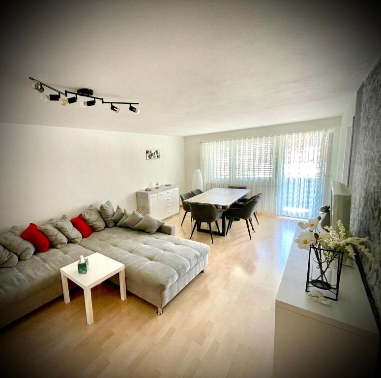 a living room with a couch and a table at Center Appartement Interlaken in Interlaken