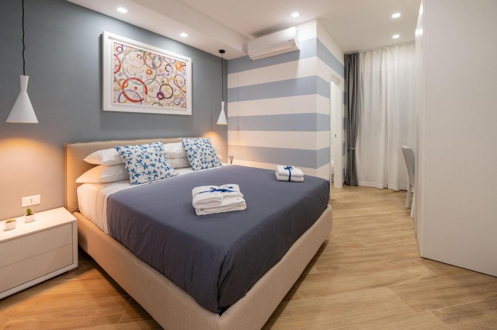 a bedroom with a bed with towels on it at Behome202 in Fisciano