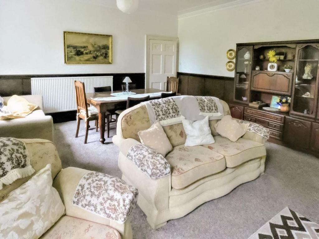 a living room with a couch and a table at Shaw House in Alton