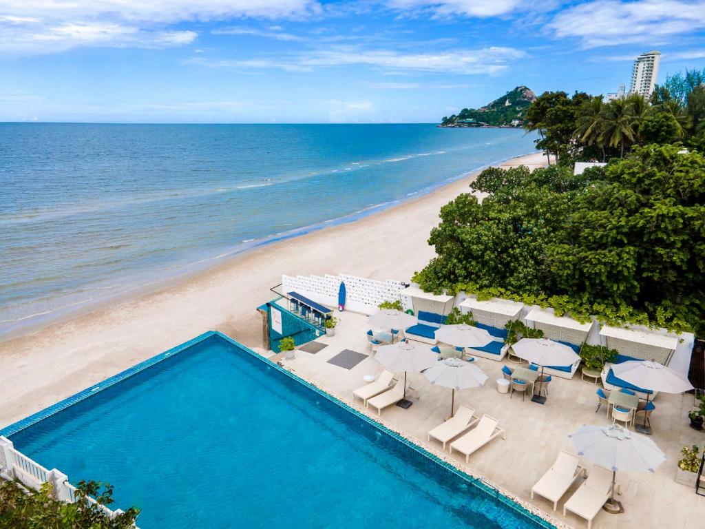 an aerial view of a beach with a swimming pool at The Rock Hua Hin Beachfront Spa Resort - SHA Plus in Hua Hin