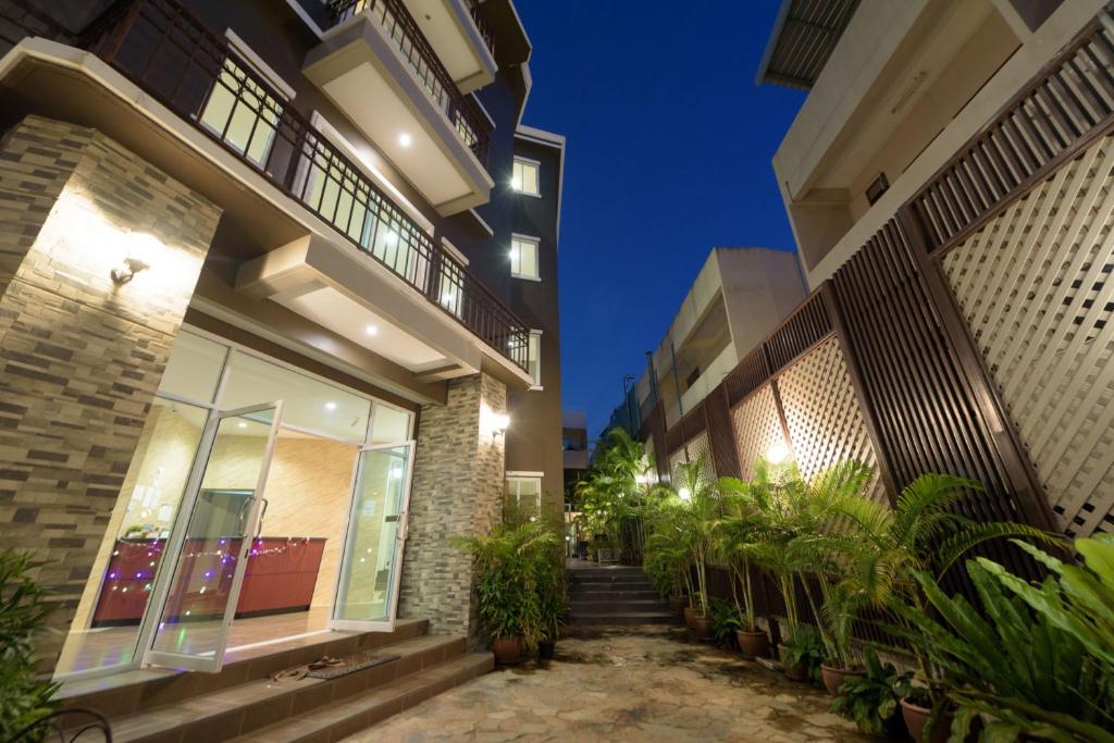 a building with some plants in front of it at The Hideaway Resort Pattaya in Pattaya South