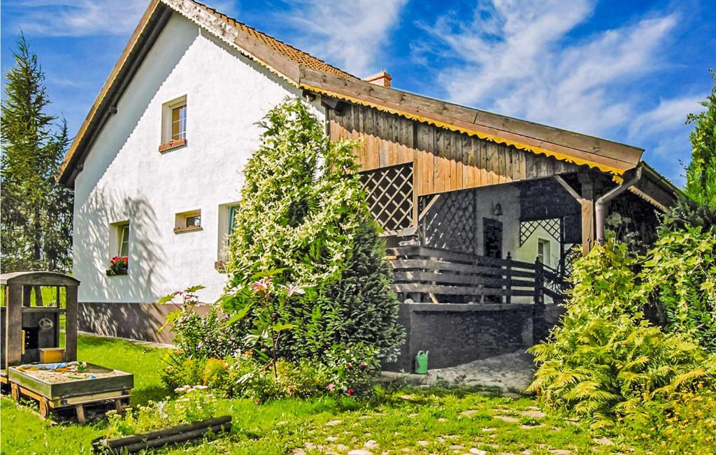 a large white barn with a wooden roof at 4 Bedroom Cozy Home In Lidzbark Warminski in Lidzbark Warmiński