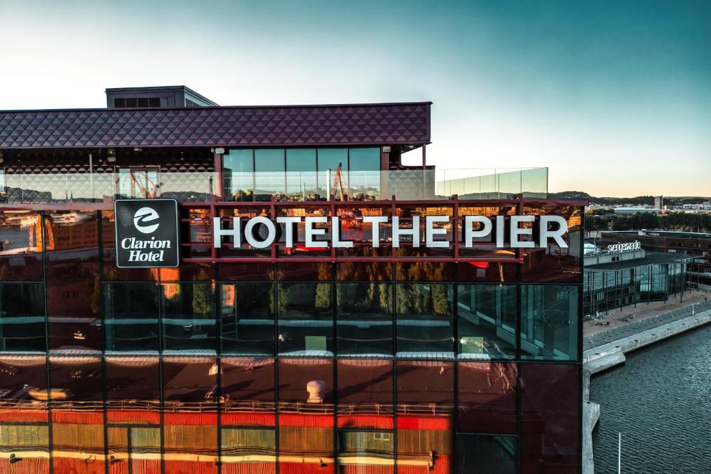 a hotel the pier sign on top of a building at Clarion Hotel The Pier in Gothenburg
