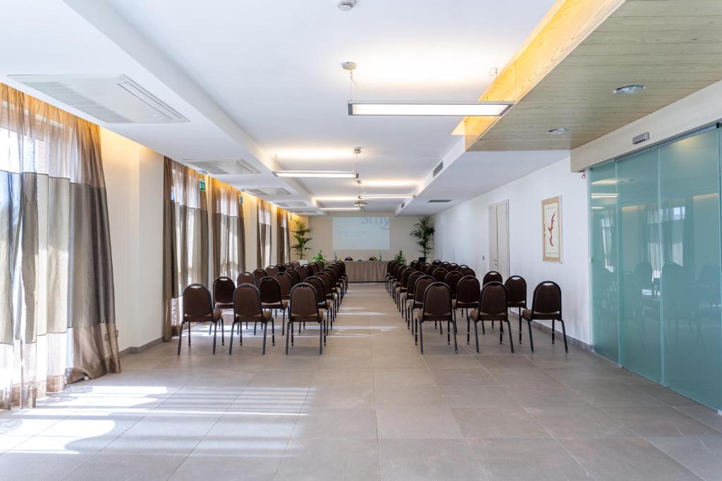 a room with a row of chairs in a room at Smy Aran Blu Roma Mare in Lido di Ostia