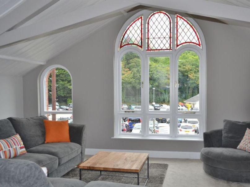 a living room with two couches and two windows at St Monicas in Fowey