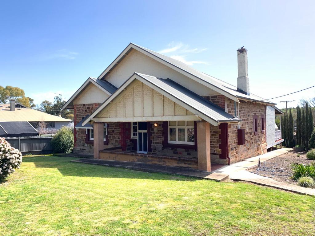 a house with a grass yard in front of it at Aberdeen Cottage in Burra