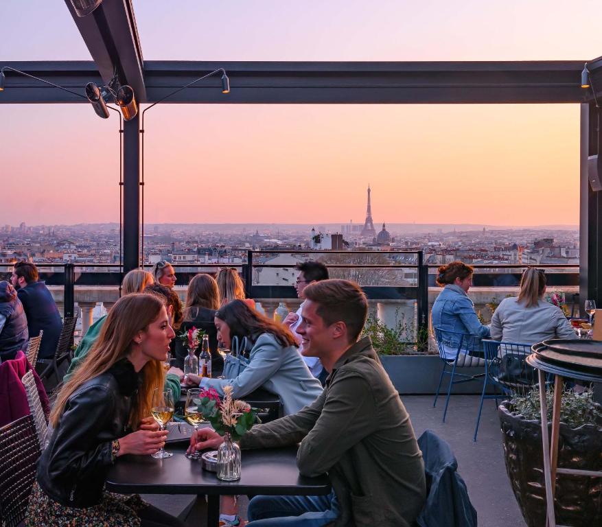 a group of people sitting at a table with a view at Terrass&quot; Hotel in Paris